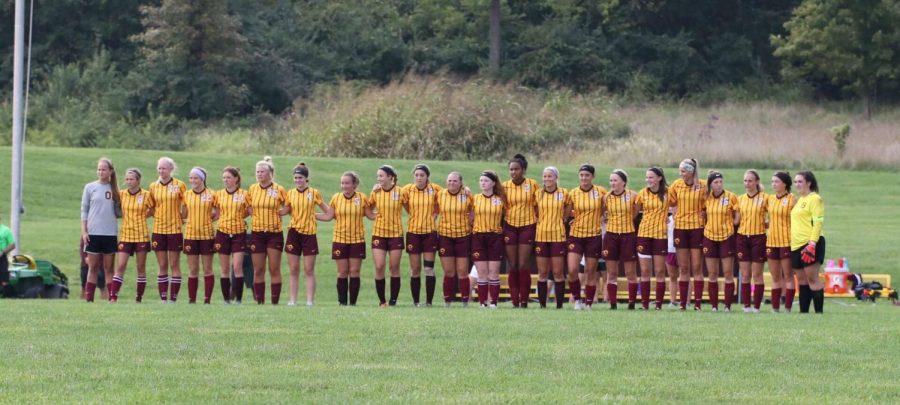 The girls soccer team stands listening to the National anthem after being introduced. Picture credit to Olivia Clayton.
