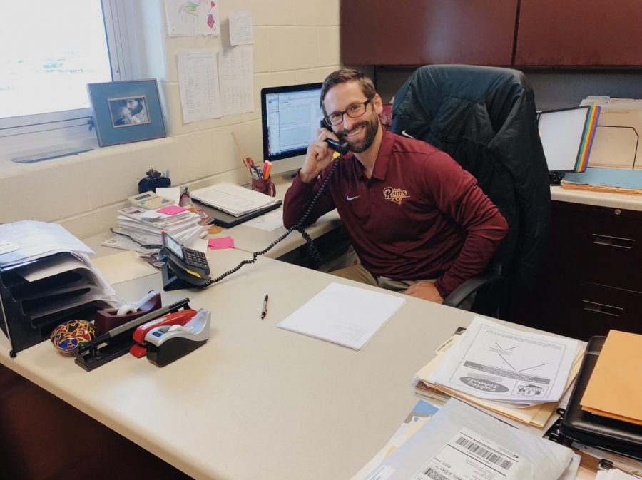 Athletic Director, Mr. Jake Richards, takes a phone call.