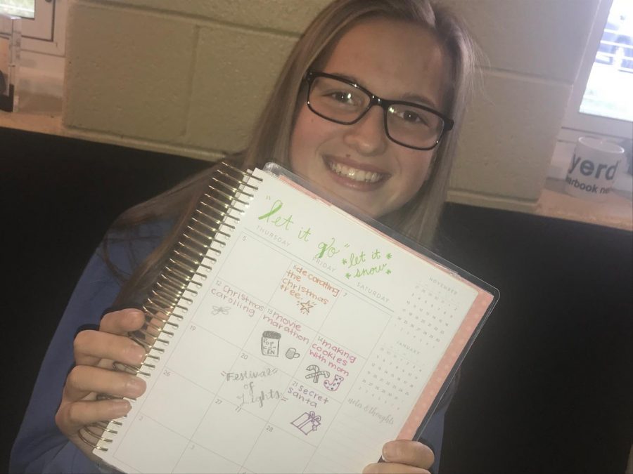 Freshman Veronica Allen is excited for the holidays, as she smiles with her newly decorated agenda. 