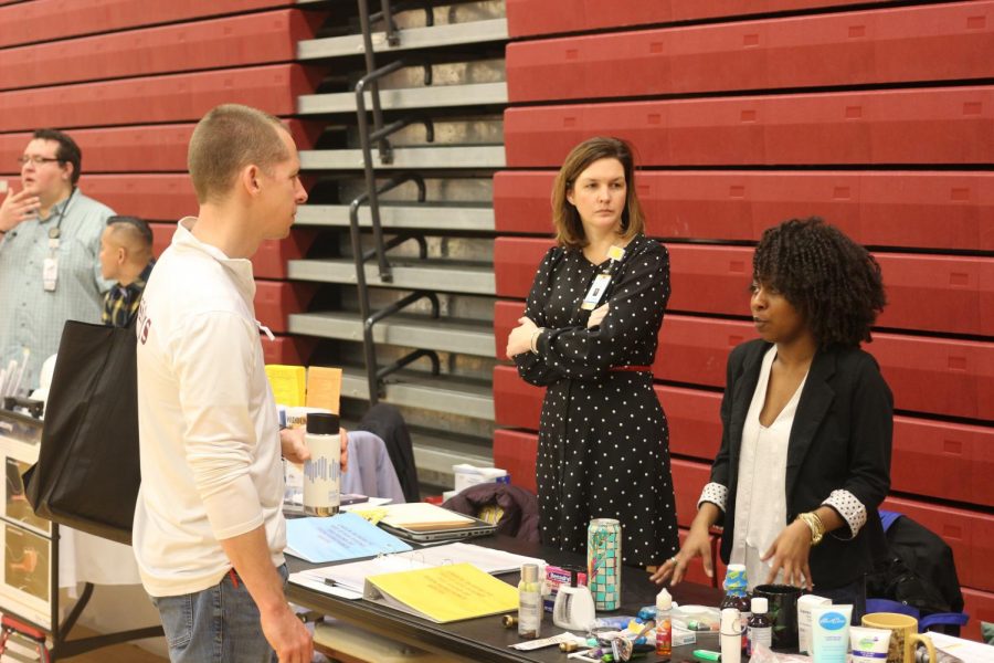 Ross High School Science teacher Brian Streng receives tips on how to properly hydrate at the TriHealth Wellness Fair. 