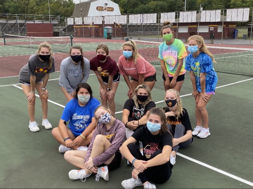 After a tough practice the girls tennis team poses for a picture. 