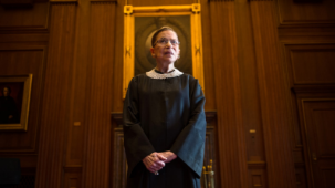 Ruth Bader Ginsburg stands before the US Supreme Court. 