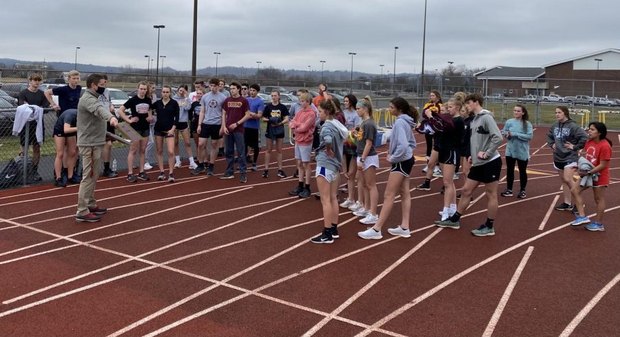 Head Coach Barnes gets the teams ready to start Friday practice on the track.