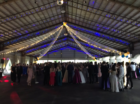 Students dance under the lights at prom.