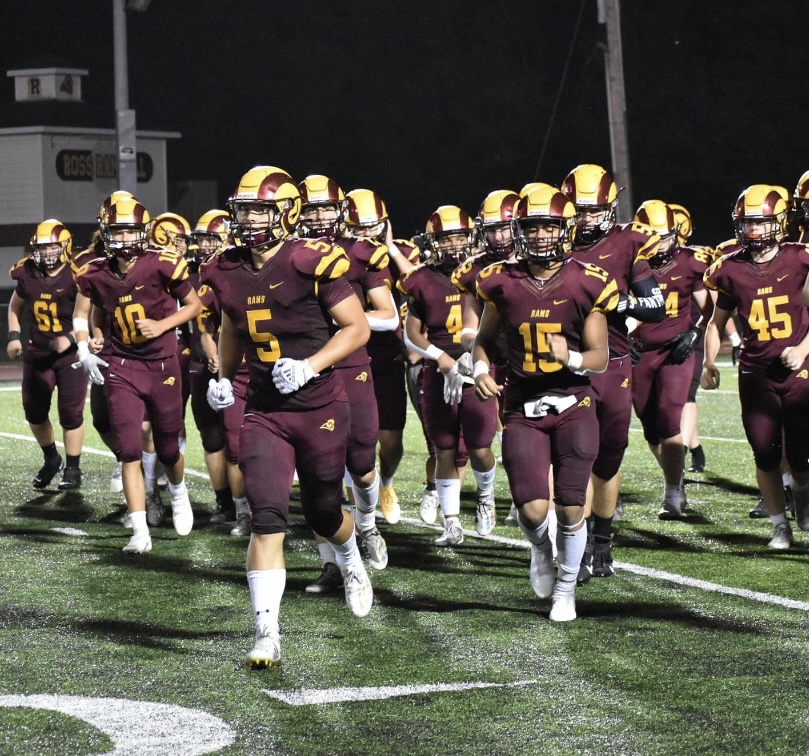 The RHS football team runs off the field after a field goal kick