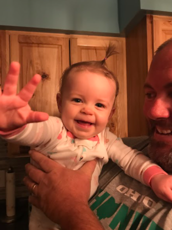 James Elliott holding his niece after giving her a bath with his wife. 