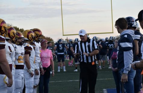 A OHSAA Official flipping a coin to start off the Ross Vs. Edgewood Varsity football game