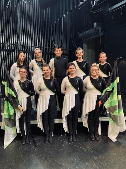 RHS color guard poses on the auditorium stage with flags for this years performance showcase entitled, ‘Fusion’. 

First Row (L to R): Samantha Bingham (9), Ava Burnette (12), Sara Nace (12), Shiann Black (11)
Back Row (L to R): Savannah Tabler (11), Gabbie Gorman (10), Shawn Vanover (9), Katie Reed (11), Marina Bacovin (10)