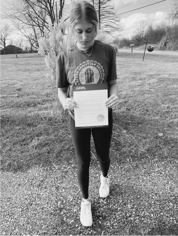 RHS senior Payton Jones holding her acceptance letter to Ozark Christian College. 