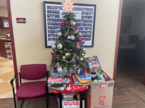 The various toys donated by students, staff, and community members are placed under the Giving Tree in Ross High School’s main office. 
