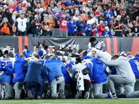 Buffalo Bills’ players pray for Damar Hamlin after suffering cardiac arrest on the football field.