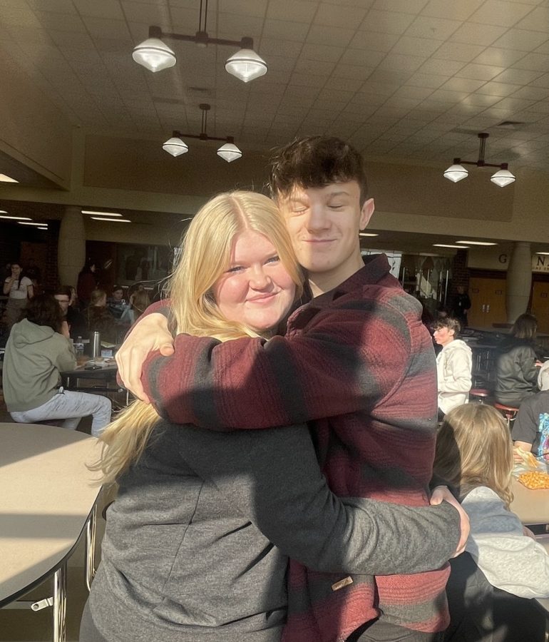 Junior Luke Niehaus and sophomore Lily Droke hug at lunchtime in the Ross High School cafeteria. 