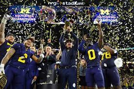 Michigan holding their trophy up high.