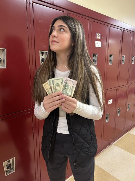 RHS Sophomore Maggie Adkinson holding money.