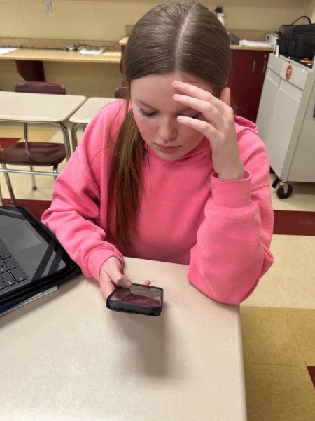 Aubrie Kirsch using a cell phone in the middle of class.